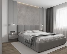 a large bed sitting in the middle of a bedroom next to a wall mounted light