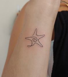 a person with a tattoo on their arm that has a starfish in the middle