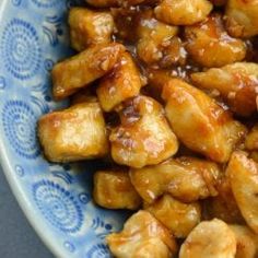 a blue and white bowl filled with fried food