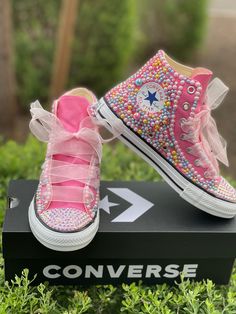 "Custom Bling Converse All Star Chuck Taylor Sneakers. All designs handmade and embellished with a variety of high quality crystals. Good for weddings, proms, homecomings, birthdays, special events or just your everyday girly girl. Bling Converse \"HIGH TOP\" Can customize to any color Embellished with pink, blue, yellow pearls Pink Crystal rhinestones Pink sheer ribbon shoe strings (original shoe strings provided with all orders) (NEW SHOES GUARANTEED) Rhinestone Bling Pearls Satin Shoelaces ** Satin Shoelaces, Upcycle Shoes, Rhinestone Converse, Converse Design, High Top Tennis Shoes, Bling Converse, Ribbon Shoes, Pink High Tops, Converse High Top