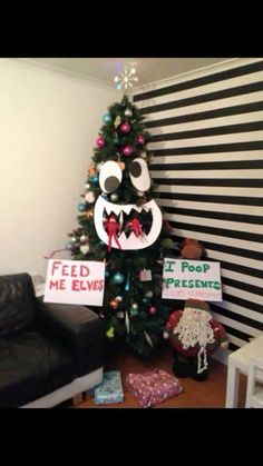 a christmas tree decorated with fake teeth and signs that read feed me elves i pop preservatis