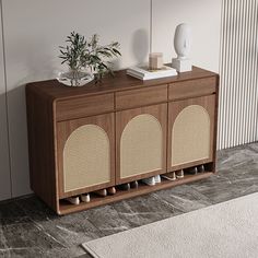 a wooden cabinet with three doors and two vases on the top, next to a rug