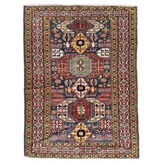 an antique persian rug with multicolored patterns and designs on the border, in various colors