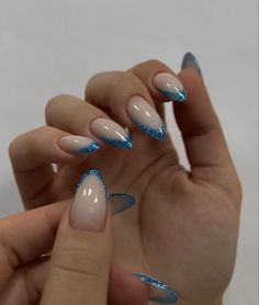 Nice Almond Nails, Blue Sparkle Tip Nails, Sparkly Blue Tip Nails, Nail Ideas Concert, Blue Sparkle Nails French, Blue Sparkly Nails Almond, Blue Holiday Nails Acrylic, Saltburn Nails, White And Blue Winter Nails