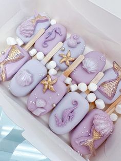 there are some cookies in the shape of letters with seashells and starfish on them