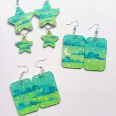 A small batch of my favorite greens on 2 teir star dangles and 2in wooden rectangles. Hand painted and sealed Add a unique touch to your jewelry collection with these hand-painted wooden earrings. Each pair is one-of-a-kind, featuring a beautiful design painted with care and precision. Not only do they make a stunning addition to any outfit, but they're also incredibly lightweight, making them comfortable to wear all day long. Whether you're dressing up for a special occasion or adding a pop of color to your everyday look, these earrings are the perfect choice. Show off your individual style and make a statement with these beautiful, hand-painted wooden earrings. Painted Earrings, Painted Jewelry, Wooden Earrings, Small Batch, Star Earrings, Small Batches, Beautiful Hand, Individual Style, Wood Art