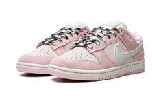 The Women’s Nike Dunk Low “Pink Foam” is a women’s-exclusive colorway of the classic basketball shoe that’s primed for warm weather wear.  This makeup of the Dunk Low features a cream suede base contrasted with Pink Foam suede overlays.  The all-suede appearance is a departure from the Dunk’s original leather build.  A white leather Swoosh is found on the sides.  “Nike” branding is embroidered on the heel and printed on the tongue tag.  Laces with black-and-white stitching appear on the cream su Womens Dunk Low, Foams Shoes, Foam Shoes, Sneakers Box, Kobe Shoes, Retro Basketball Shoes, Tenis Nike, Basic Hoodie, Sneaker Release