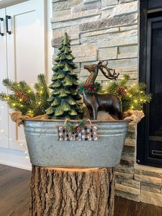 a metal tub filled with christmas decorations next to a fireplace