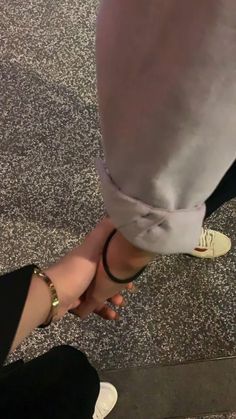 two people are holding hands with each other