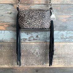 Introducing the Itty Bitty Designer Purse! The smallest purse in our Designer collection brings cowboy flair with its embossed leather or one of a kind hides! Perfect for carrying just the essentials with a touch of Western charm. Ideal for any occasion! • 10"L x 6"H x 3"W with stiff bottom• Soft-sided with premium genuine hair-on hide and leather• 1 interior pocket• 1/2"W x 48"L adjustable shoulder strap• Zippered top closure with leather pull• Heavy-weight cotton interior lining• Made in the U Classy Cowgirl, Purse Organization, Purses Designer, Itty Bitty, Leather Pulls, Small Purse, British Indian Ocean Territory, Designer Collection, Embossed Leather