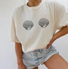 Details• Beach Shells Oversized Ivory Summer T-Shirt• Comfort Colors Brand• Fabric has stretch and has a relaxed fit• Short sleeves with a crew neckline• Pair this cute tee with shorts!Material• 100% cotton• Materials may have natural variations• Colors may vary from different viewing device Trendy Cream Summer T-shirt, Beige Short Sleeve T-shirt For Loungewear, Beige Graphic Tee For Summer, Beige Crew Neck Top For Vacation, Summer Beige Crew Neck Top, Oversized Beige T-shirt For Summer, Cream Graphic Print Top For Summer, Beige Crew Neck Top For Beach, Cream Short Sleeve T-shirt For Summer