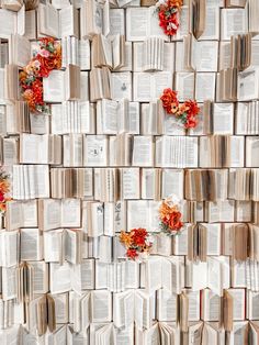 many open books with flowers on them are arranged in the shape of a wall ornament