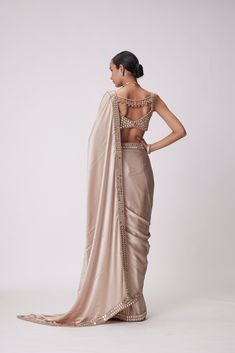 Beige Satin Saree Clubbed with Real Hand Cut Mirror Embroidered Sleeveless Blouse.From Vvani Vats Jugmug's collection.DELIVERY TIMEPlease allow 8-12 weeks for your outfit to arrive.FABRIC DETAILSSaree - SatinBlouse - GeorgetteProfessional cleaning only. Gold Satin Saree, Satin Sari, Mirror Blouse, Mirror Embroidery, New Saree Blouse Designs, Weddings Receptions, Indian Wedding Wear, Satin Saree, Stylish Sarees