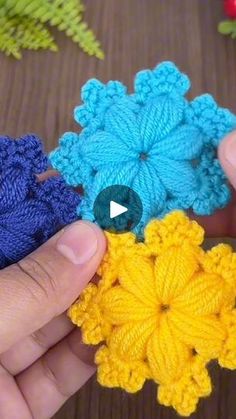 crocheted flowers being held by two hands