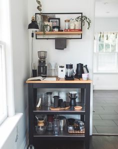 a coffee bar with shelves and cups on it