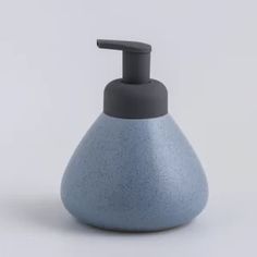 a blue soap dispenser sitting on top of a white table