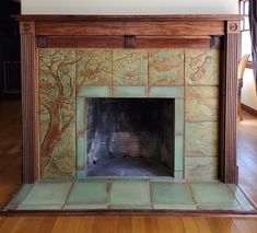 a fireplace with a tree painted on it