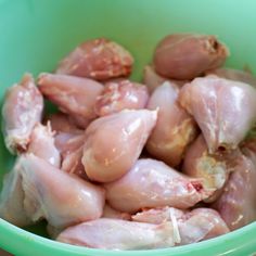 some chicken in a green bowl on a table