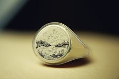 Experience the serene beauty of the East with our Custom Gold Round Shaped Signet Ring, intricately engraved with a Japanese landscape. This exquisite ring captures the essence of traditional Japanese scenery, such as Mt. Fuji, cherry blossoms, or tranquil gardens, making it a perfect piece for those who appreciate art and culture. Crafted from high-quality gold, the round shape enhances the detailed landscape engraving, offering a sophisticated yet bold statement. Ideal for art enthusiasts or a Artistic Engraved Rings As A Gift, Unique Engraved Round Ring, Artistic Engraved Rings For Gift, Round Intaglio Signet Ring Gift, Intaglio Signet Ring As A Gift, White Intaglio Ring As Gift, Intaglio Signet Ring Gift, Nature-inspired Engraved Ring As A Gift, Carved Signet Ring As Gift