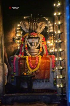 the idol is decorated with garlands and lights