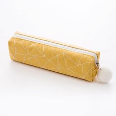 a yellow pencil case sitting on top of a white table