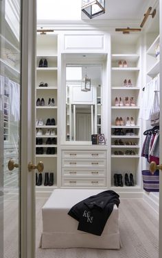 the closet is full of shoes and clothes