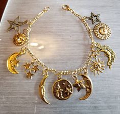 "This celestial moon stars and sun inspired bracelet has 12 gold tone charms. The charms are from finding companies that have discontinued some of the the charms. So when I have used all of the discontinued charms there will be no more bracelets exactly like this one. However, I do have many charms with moon stars and suns so I can create a bracelet similar to the one shown in the picture. I buy the gold tone Figaro bracelet new from a findings company in New York in bulk length and cut it to 7\ Cheap Bohemian Beaded Necklaces For Festivals, Cheap Gold Bracelets With Vintage Charm, Sun Bracelet, Victorian Vintage, Jewelry Accessories Ideas, Dope Jewelry, Recycled Fashion, Funky Jewelry, Jewelry Lookbook