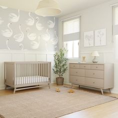 a baby's room with a crib and dresser