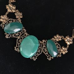 This bracelet was made by Sadie Green company in the seventies. Sadie Green would use antique and vintage components and marry them together to make great jewelry. They specialize in using green sea glass, these smooth pieces being a jade color.  Please note that the large 1.25 x .75 one in the middle has been cracked, but still intact. The price reflects this.  The glass cabs are set into antiqued brass filigree settings. The bracelet is all linked together and measures 7 inches fitting an average woman's wrist. The closure is a tongue in barrel style and still works well. The detail of the metal open work links are fantastic. It is a classic Belle Epoque design and weighty due to the glass components. This piece of jewelry is sent in a bubble pack envelope via US postal service, first cl Ornate Green Bracelet Jewelry, Ornate Green Jewelry With Intricate Design, Vintage Jade Jewelry For Jewelry Making, Vintage Green Bangle Jewelry, Victorian Green Bracelet Jewelry, Antique Green Handmade Bracelet, Victorian Green Bracelets For Gifts, Victorian Green Bracelets As Gift, Victorian Style Green Bracelets For Gifts