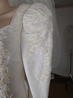 the back of a white wedding dress on display