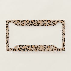 an animal print license plate holder on a white background with black and brown spots,