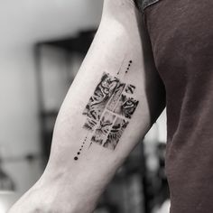 a black and white photo of a tiger tattoo on the left arm with geometric shapes