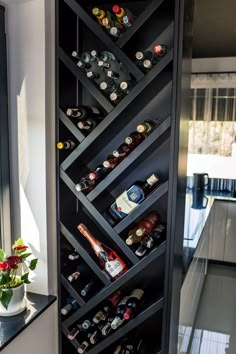 a wine rack with many bottles in it