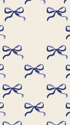 a blue and white bow pattern on a light colored wallpaper with dark blue lines