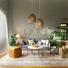 a living room filled with lots of furniture next to a large window and potted plants