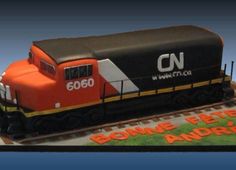 a cake shaped like a train engine on top of a track with the words cnn above it