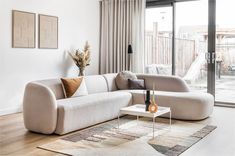 a living room filled with furniture next to a sliding glass door