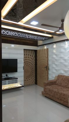 a living room filled with furniture and a flat screen tv mounted on the wall above it