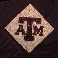 the texas a & m diamond logo is displayed on a black jacket with sequins