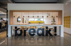 an open concept kitchen and dining area with the word geek spelled out on the counter