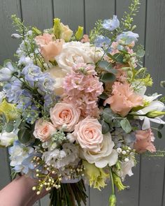 a person holding a bouquet of flowers in their hand