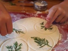 someone is making homemade christmas cookies on a table