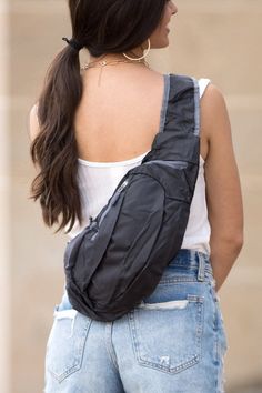 a woman with a black fanny bag on her back