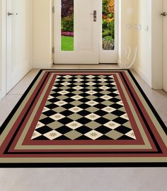 a black and white checkered area rug in front of a door with two glass doors