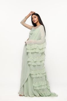 Get this festive look in a fresh mint lehenga saree, accentuated with ruffles annd gota details on the dupatta. The look is completed with a sequined sheer crop top . . . . . . #diyaskin #diyaonline #partyoutfit #ootd #ootn #styleinspo #indiansuits #indian #sarees #fashion #ethnic #stylishsarees Mint Lehenga, Sheer Crop Top, Lehenga Saree, Party Wear Indian Dresses, Stylish Sarees