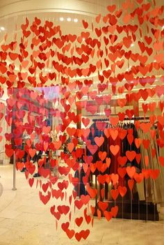 red hearts hanging from the ceiling in a store