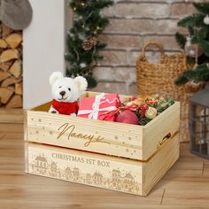 a teddy bear sitting in a wooden box filled with christmas decorations and gifts on a table