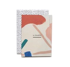 two notebooks with different designs and words on the cover, one is white and blue