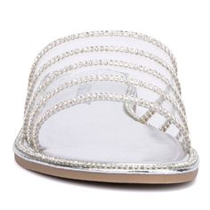 Elegant in its simplicity, the Nadia slide captures attention with its distinctive striped sparkle d�cor on a clear top. Feminine and delicate, this chic slide adds a touch of glamour to any outfit, whether you're dressing up for a special occasion or adding a bit of shine to your everyday look. Perfect for any event, the Nadia combines understated elegance with a hint of sparkle, making it a versatile addition to your footwear collection. Glamorous Clear Sandals For Summer, Spring Silver Sandals With Clear Strap, Glamorous Sandals With Clear Strap For Spring, Glamorous Clear Open Toe Sandals, Elegant Flat Jelly Sandals, Glamorous Clear Sandals For Spring, Clear Sandals, Acupressure Massage, Olivia Miller