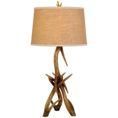 a lamp that is sitting on top of a wooden base with a light shade over it